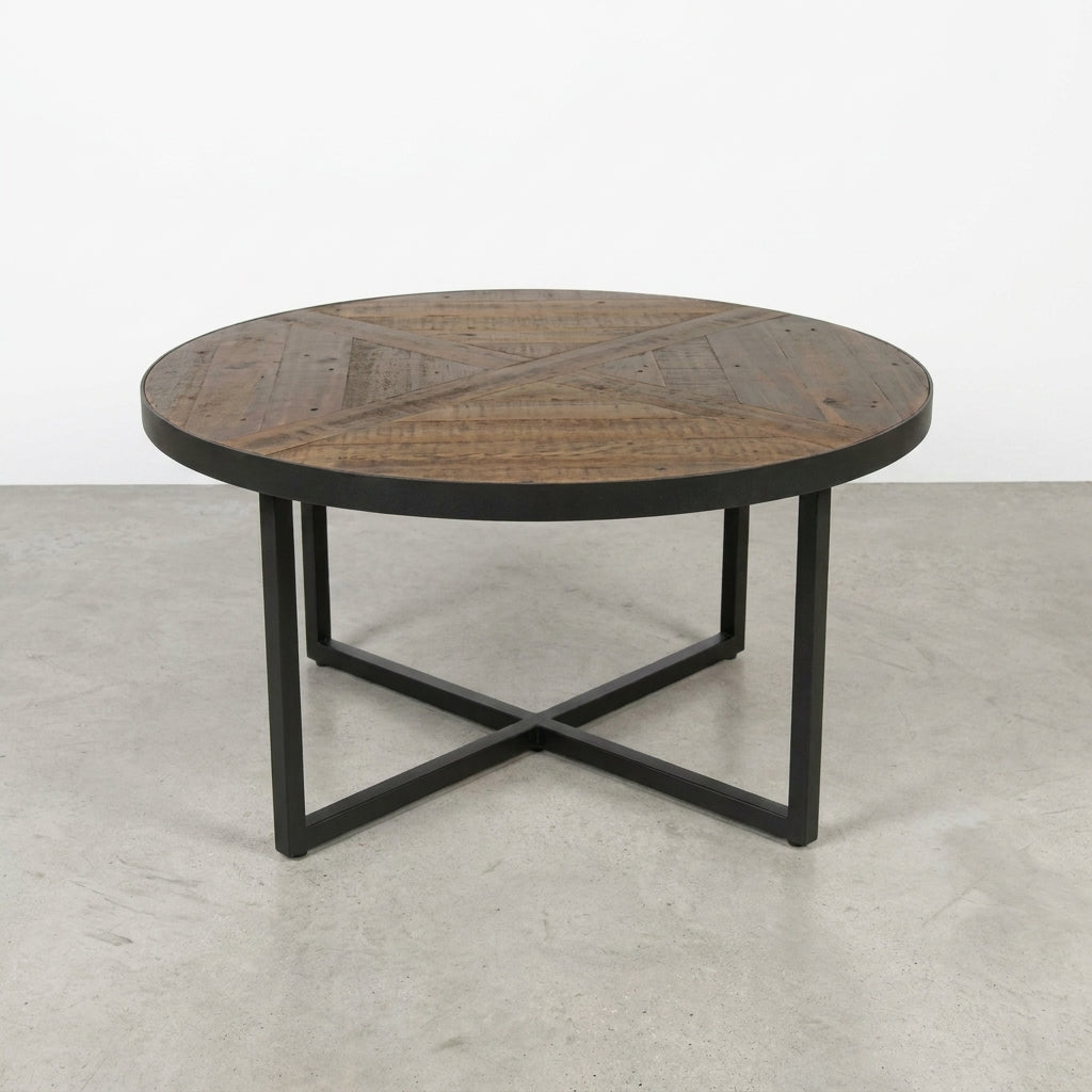 Round wooden coffee table with a metal X-shaped base.