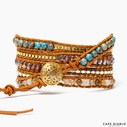 Wrap bracelet with blue stones, gold beads, and ornate button closure.