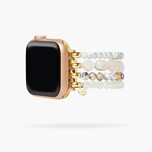 Rose gold watch with beaded strap and gold accents.
