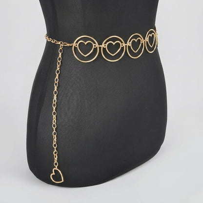 Gold heart chain belt on black mannequin.