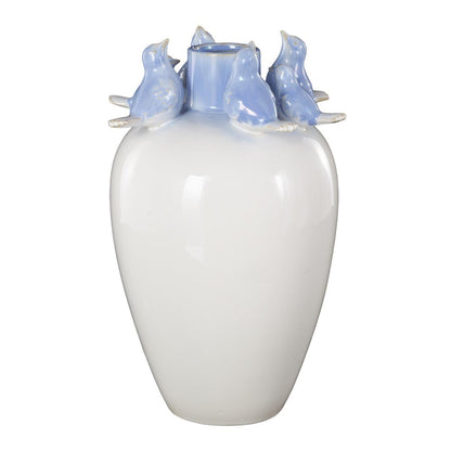 White vase with blue birds perched around the rim.