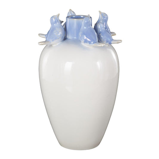 White vase with blue birds perched around the rim.