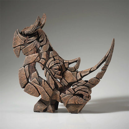 Abstract stone sculpture of a dinosaur-like creature with a segmented design.