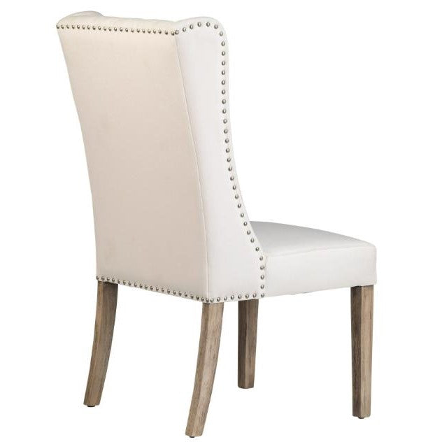 Elegant white chair with studded trim and wooden legs, viewed from the back.