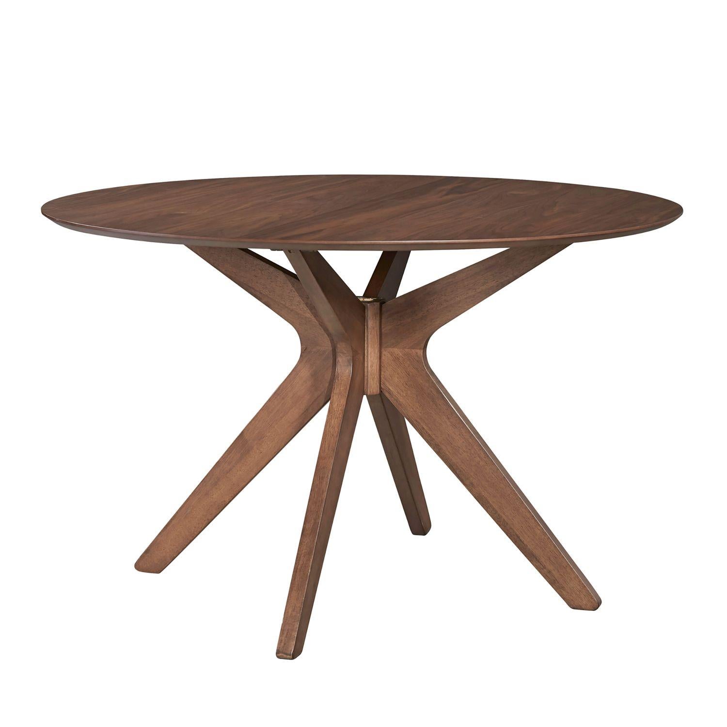 Round wooden table with geometric leg design.