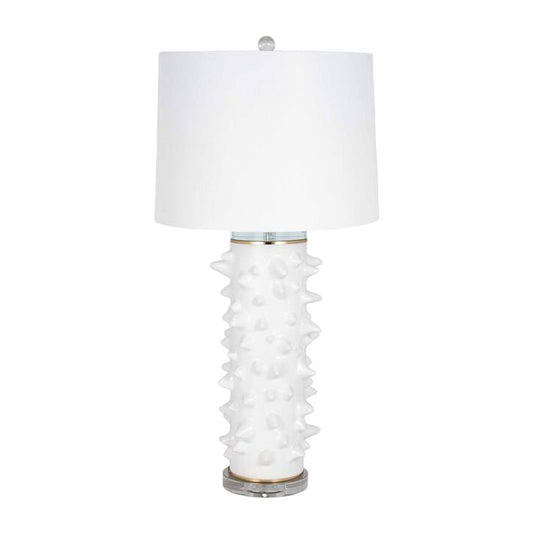 White spiked base lamp with round white lampshade.