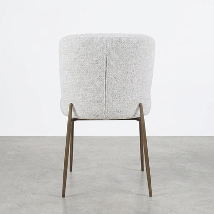Cream upholstered chair with wooden legs on a plain background.