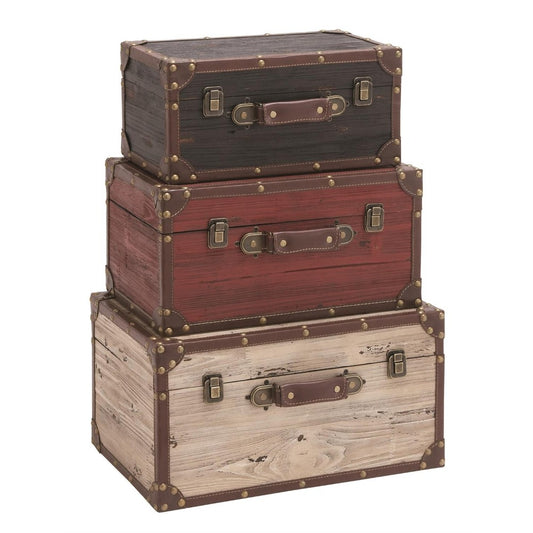 Three stacked vintage trunks in varying wood tones.