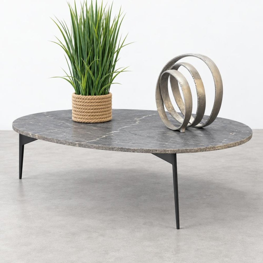 Marble table with a potted plant and metal sculpture.