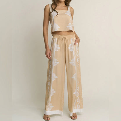 Woman in beige floral two-piece outfit against a plain background.