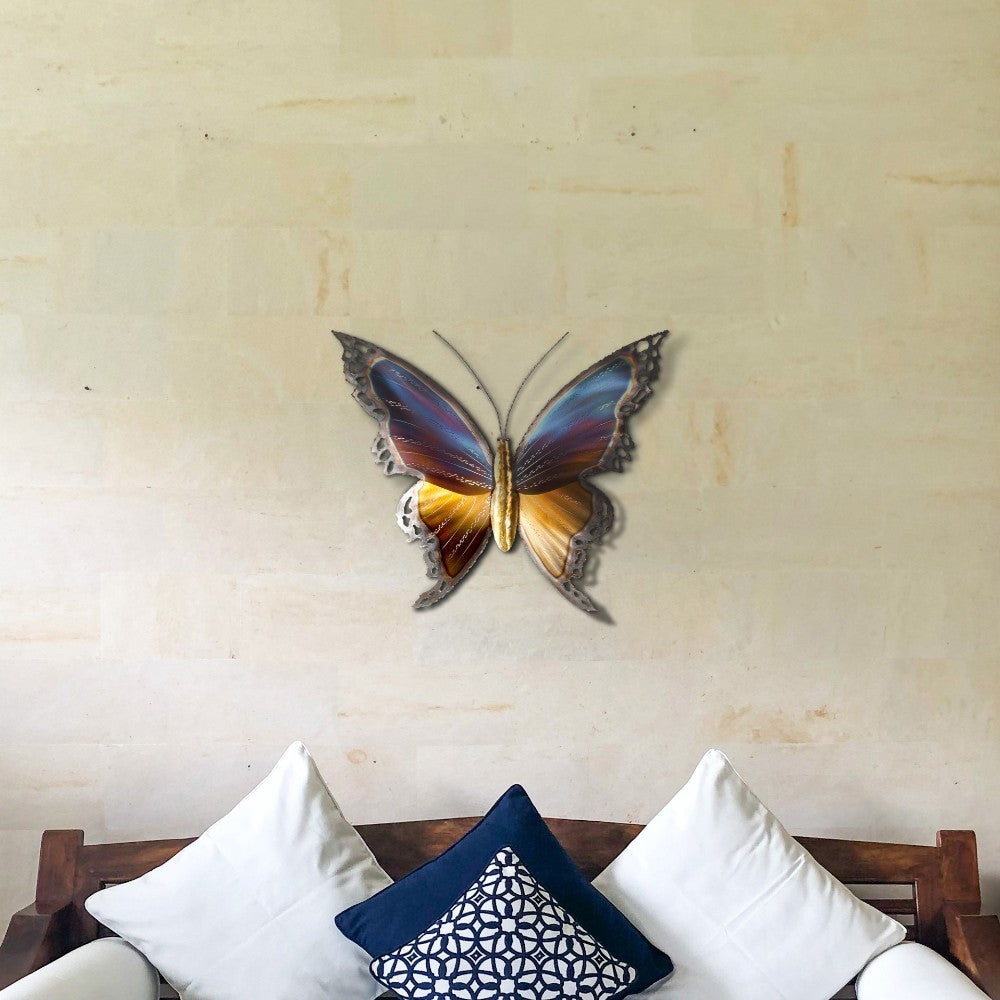 Metal butterfly decor above a sofa with patterned cushions.