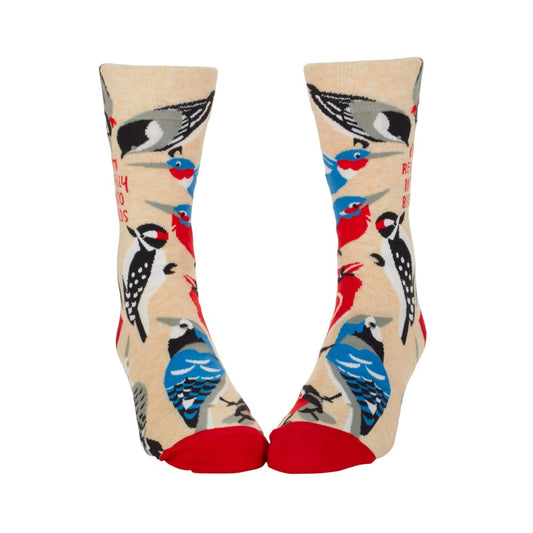 Colorful bird-patterned socks with red toes and beige background.