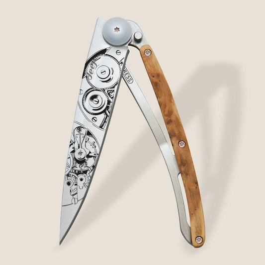 Intricate folding knife with gear design and wooden handle.