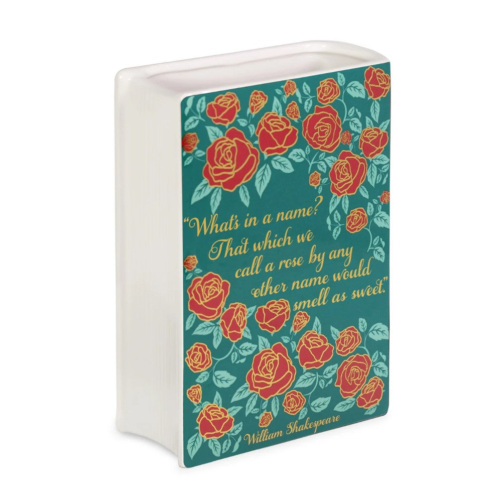 Decorative book vase with red roses and a Shakespeare quote.