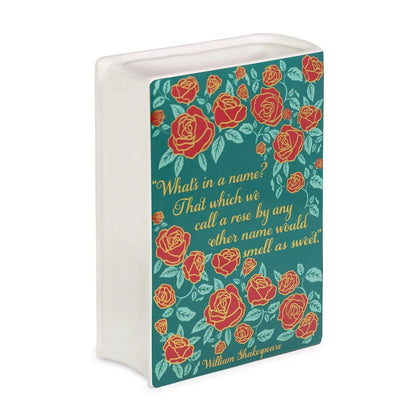Decorative book vase with red roses and a Shakespeare quote.