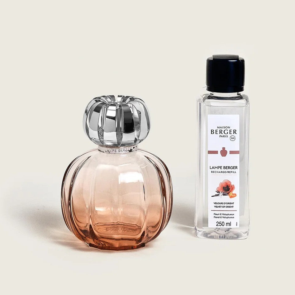 Elegant glass lamp and refill bottle on a neutral background.