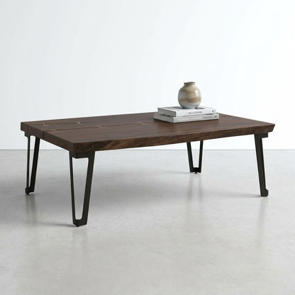 Dark wooden table with metal legs and decorative inlays.