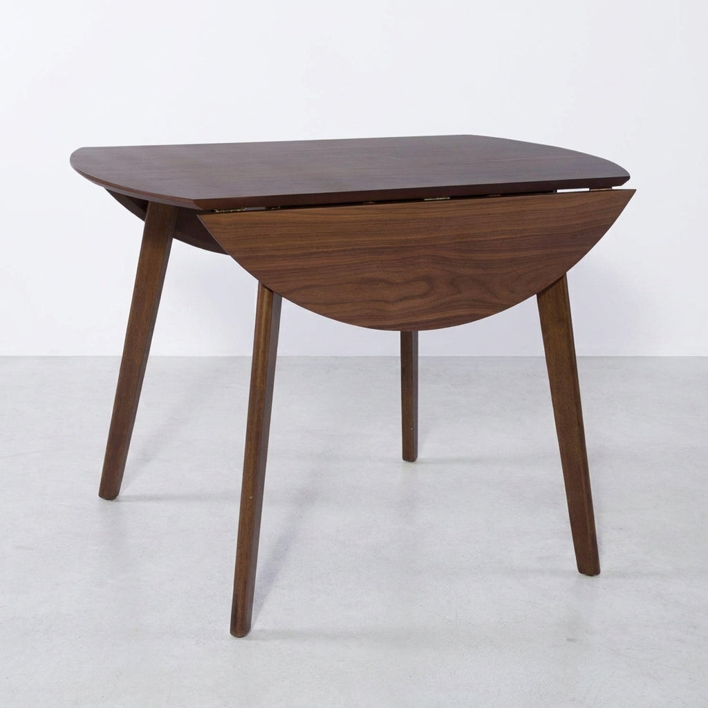 Wooden table with foldable semicircular leaves on both sides.