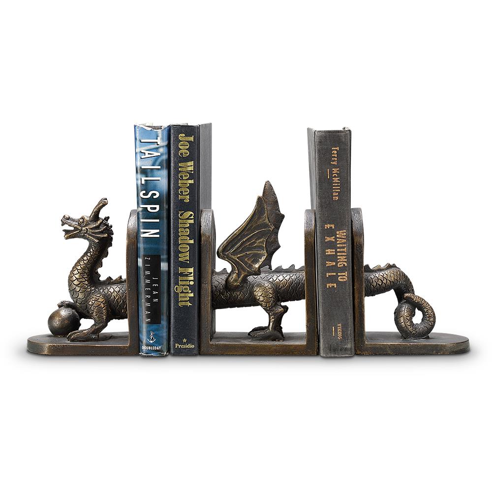 Dragon bookends holding three books upright.