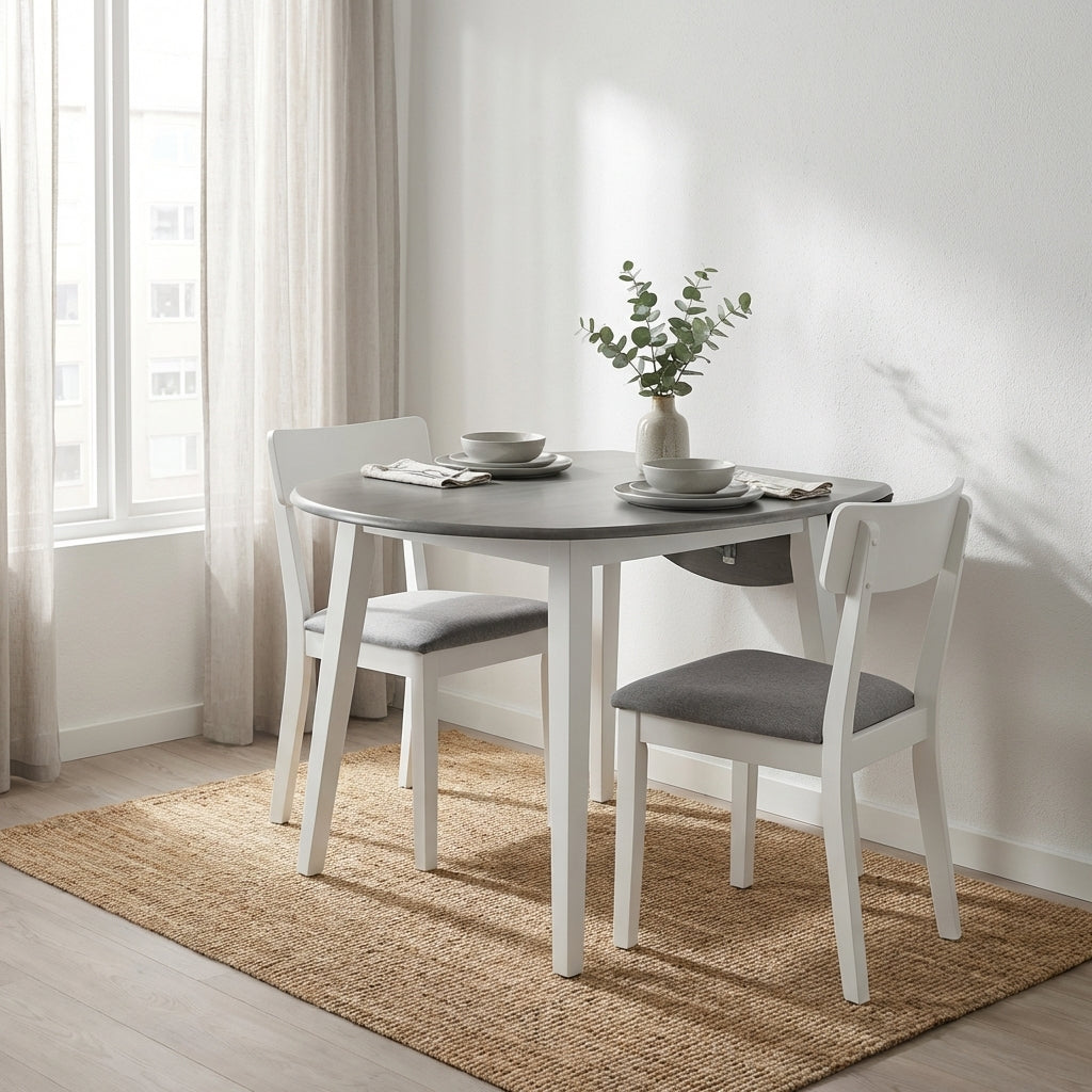 Cozy dining area with table, two chairs, and a vase on a rug by the window.