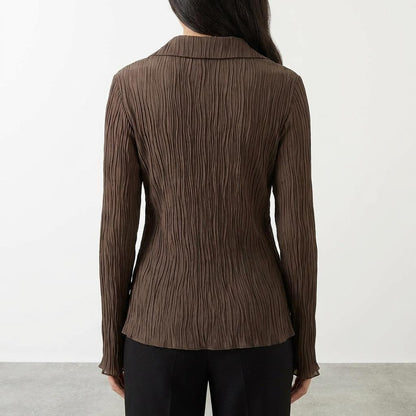 Back view of a brown crinkled blouse with collar, worn by a person with long hair.