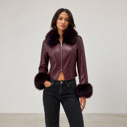 A model wears a burgundy leather jacket with a plush fur collar and cuffs.