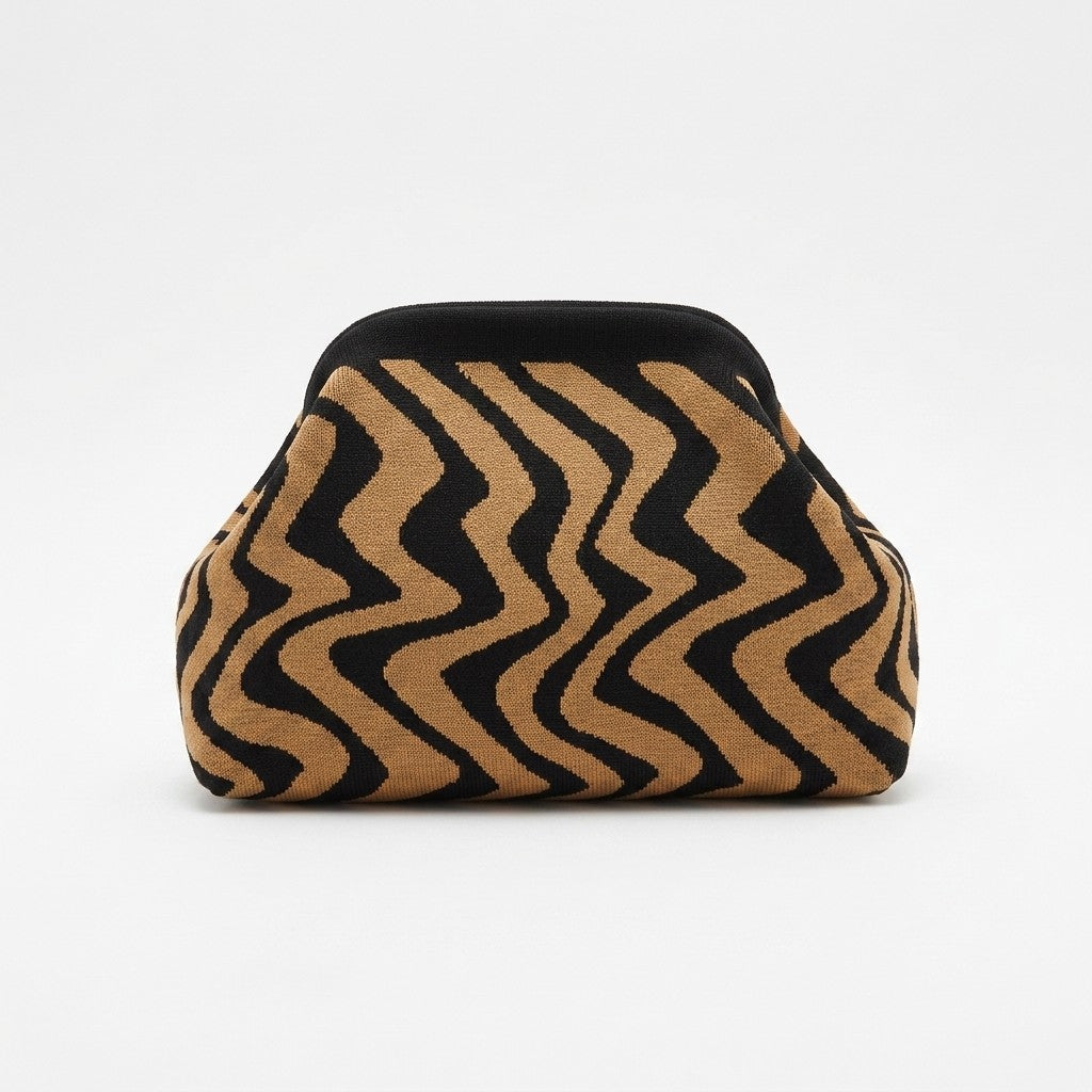 Brown and black wavy patterned sofa against white background.