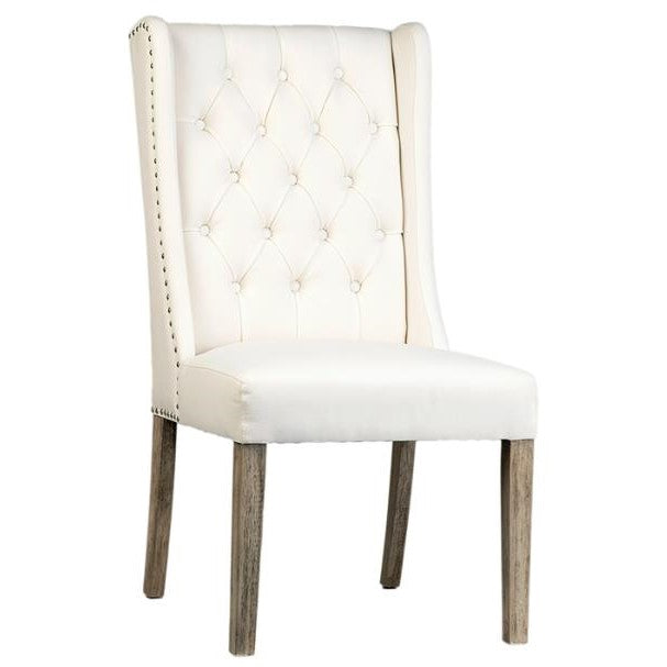 White tufted chair with wooden legs.