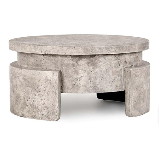 Round modern concrete coffee table with textured finish.