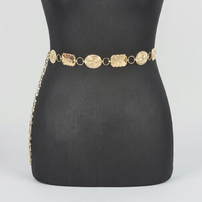 Gold chain belt on a black mannequin.