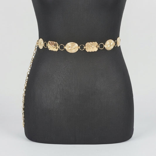Gold chain belt on a black mannequin.