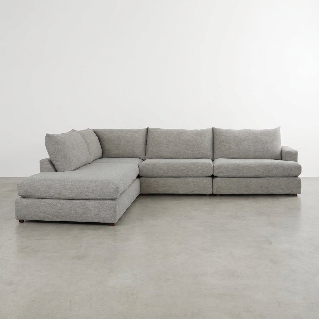 Gray L-shaped sectional sofa with plush cushions.