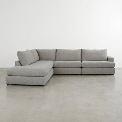 Gray L-shaped sectional sofa with plush cushions.