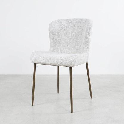 Modern white chair with metal legs against a plain background.