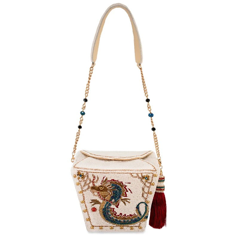 Beaded bag with dragon design, gold chain, and tassel.