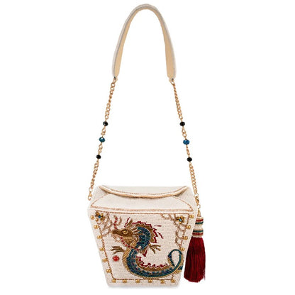 Beaded bag with dragon design, gold chain, and tassel.