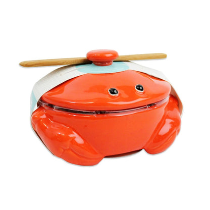 Cute crab-shaped ceramic container with a lid and wooden spoon on top.