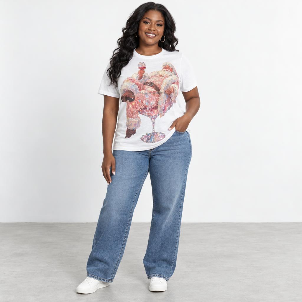 Smiling woman models a graphic white T-shirt, wide-leg jeans, and white sneakers.