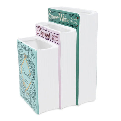 Three book-shaped ceramic vases: Snow White, Rapunzel, Cinderella.