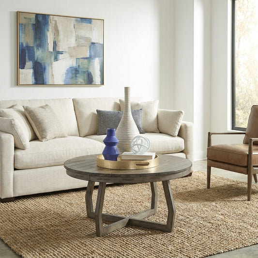 Modern living room with beige sofa, abstract art, and wooden coffee table.