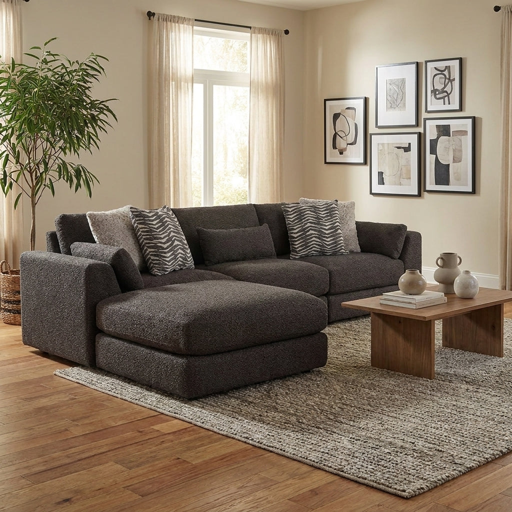 Dark L-shaped sofa with patterned pillows.