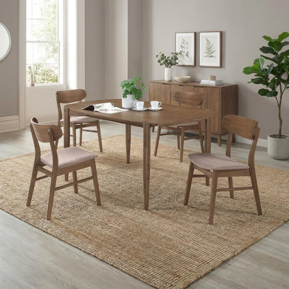 Wooden dining set with four chairs on a light rug in a modern room.
