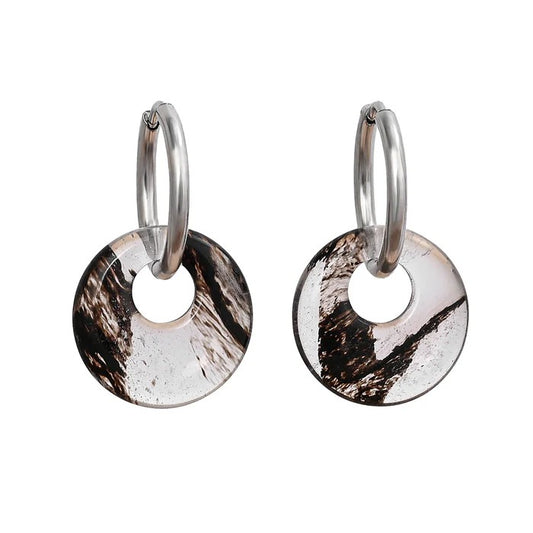 Silver hoops with circular, marbled brown and clear pendants.
