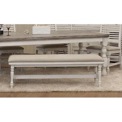 Rustic dining table with beige bench on a light carpet.
