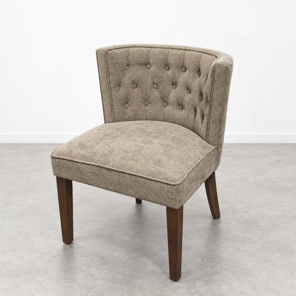 Beige upholstered chair with tufted backrest.