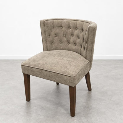 Beige upholstered chair with tufted backrest.