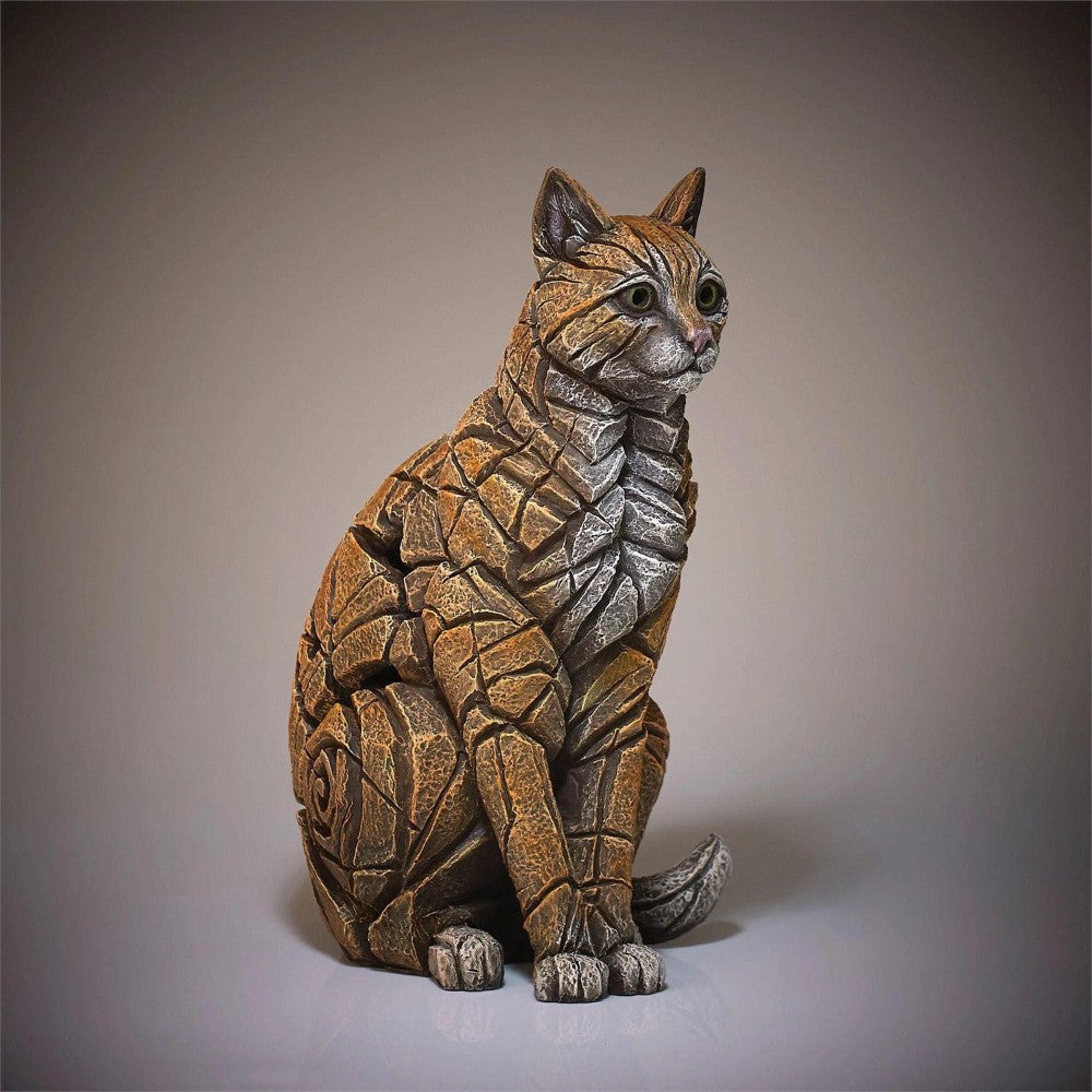 Mosaic-like cat sculpture with a textured, stone-like surface.