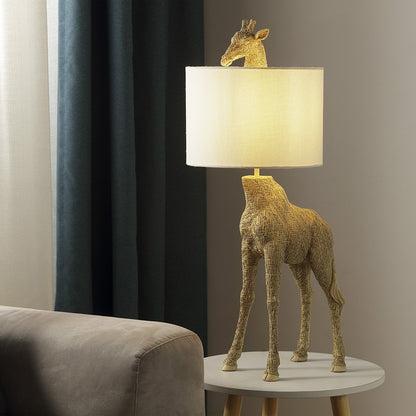 Quirky giraffe lamp with textured base on a round table.