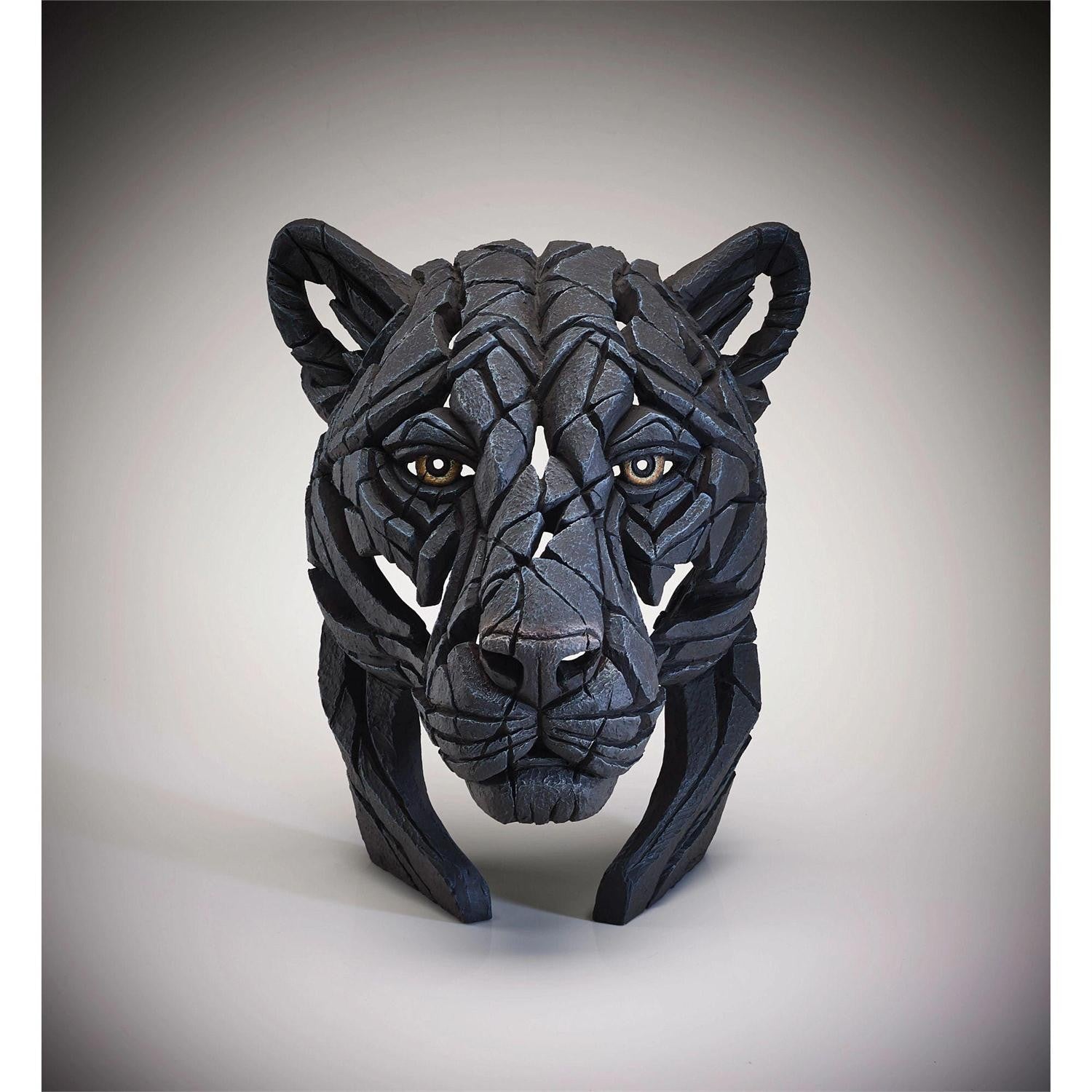 Jaguar head sculpture made of geometric, stone-like pieces.