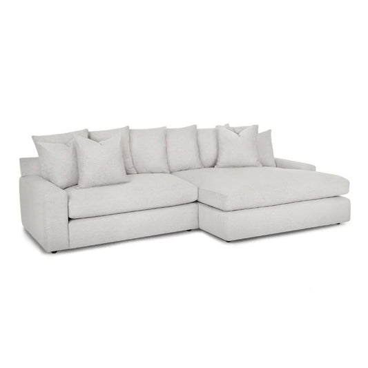 Light gray sectional sofa with plush cushions.